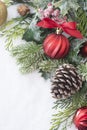 Christmas background with balls, baubles and green fir branches, pine cones, on white snow background. Winter holidays. Christmas Royalty Free Stock Photo