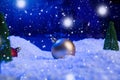 Christmas background with Christmas balls on snow over fir-tree, night sky and moon. Shallow depth of field. Christmas Royalty Free Stock Photo