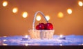 Christmas background with basket with red apples, candles, snow and bokeh lights Royalty Free Stock Photo