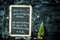 On a Christmas background a blackboard with a message from child to father: Drive carefully, we are waiting for you Royalty Free Stock Photo