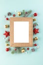 Christmas background. Blank xmas photo frame withffir tree branches, holiday decorations on blue background Royalty Free Stock Photo