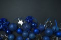 Christmas background Christmas blue deco bubblers on a dark black background. Christmas blue decoration. New Year card. Space for