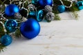 Christmas background with blue ornaments, silver beads and pine Royalty Free Stock Photo