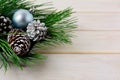 Christmas background with blue ornaments, silver and snowy pinecones Royalty Free Stock Photo