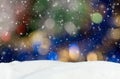 Christmas background with blue, yellow and white bokeh lights and falling snow Royalty Free Stock Photo