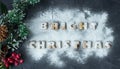 Christmas background with branch of christmas tree and baked gingerbread words bright christmas with powdered sugar