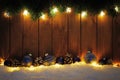 Christmas background with branches, lights and blue baubles