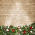 Christmas background with branches, mistletoe and holly on wood