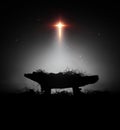 Christmas background with bright cross shaped big star and baby Jesus birth in manger