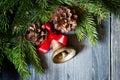 Christmas background with a bronze bell, pine cones and spruce p Royalty Free Stock Photo