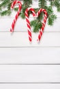 Christmas background with candies and fir tree border on wood Royalty Free Stock Photo