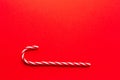 Christmas background.A candy cane on a red background, Royalty Free Stock Photo