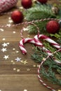 Christmas background with candy canes, golden glitter and decorations on wooden board. Copy space Royalty Free Stock Photo