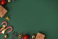 Christmas background with cardboard gift boxes, candy canes and golden Christmas tree toys. Festive feeling of upcoming holidays. Royalty Free Stock Photo