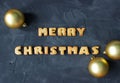 Christmas background with Christmas balls and baked gingerbread words merry christmas . creative idea
