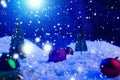 Christmas background with Christmas balls on snow over fir-tree, night sky and moon. Shallow depth of field. Christmas background Royalty Free Stock Photo