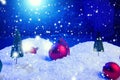 Christmas background with Christmas balls on snow over fir-tree, night sky and moon. Shallow depth of field. Christmas background Royalty Free Stock Photo