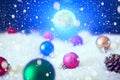 Christmas background with Christmas balls on snow over fir-tree, night sky and moon. Shallow depth of field. The elements of this Royalty Free Stock Photo