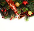 Christmas background. Christmas boarder with fir tree branch with cones and ornament. Christmas baubles in golden and red colour. Royalty Free Stock Photo