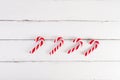 Christmas background. Christmas canes on a white wooden background