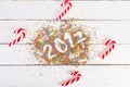 Christmas background. Christmas canes on a white wooden background. 2017 written with Color sprinkling