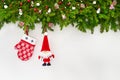 Christmas background. Christmas decoration, fir tree with Santa and mitten on white wooden background. Royalty Free Stock Photo