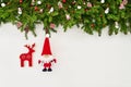 Christmas background. Christmas fir tree branch with Santa and Christmas socks on white wooden background. Copy space Royalty Free Stock Photo