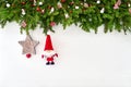 Christmas background. Christmas fir tree branch with Santa on white wooden background Royalty Free Stock Photo