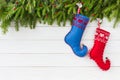 Christmas background. Christmas fir tree with decoration, red and blue Christmas socks on white wooden background, copy Royalty Free Stock Photo