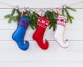 Christmas background. Christmas fir tree and fleece socks on white wooden board background with copy space. Royalty Free Stock Photo