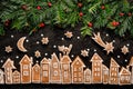 Christmas background, Christmas gingerbread town, image created from gingerbread cookies houses and fresh yew branches