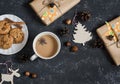 Christmas background - christmas homemade gifts, decorations, tea and biscuits. On a dark background, top view. Royalty Free Stock Photo