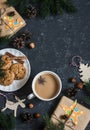 Christmas background - christmas homemade gifts, decorations, tea and biscuits. On a dark background, top view. Royalty Free Stock Photo