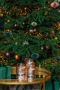 Christmas background, Christmas tree decorated with festive balls, gift box and glass vases. Soft selective focus
