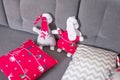 Christmas background with classic decoration, grey sofa and red and white pillow with rabbit toys. Cozy warm home. Winter holidays Royalty Free Stock Photo