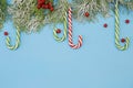 Christmas background or composition with fir branches and candy sugar cane. Christmas and New Year concept. Flat lay. Top view. Royalty Free Stock Photo