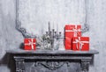 Christmas background concept. Ancient fireplace with a candlestick and gift boxes. Royalty Free Stock Photo