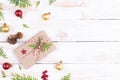 Christmas background concept. Top view of Christmas gift box with spruce branches, pine cones, red berries and bell Royalty Free Stock Photo