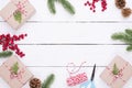 Christmas background concept. Top view of Christmas gift box with spruce branches, pine cones, red berries and bell Royalty Free Stock Photo