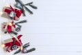 Christmas background concept. Top view of Christmas gift box with spruce branches, pine cones, red berries on white wooden table Royalty Free Stock Photo