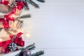 Christmas background concept. Top view of Christmas gift box with spruce branches, pine cones, red berries on white wooden table Royalty Free Stock Photo