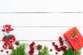 Christmas background concept. Top view of Christmas red gift box with snowman decoration, spruce branches, pine cones, Royalty Free Stock Photo