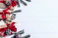 Christmas background concept. Top view of Christmas gift box with spruce branches, pine cones, red berries on white wooden table Royalty Free Stock Photo