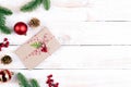 Christmas background concept. Top view of Christmas gift box with spruce branches, pine cones, red berries and bell Royalty Free Stock Photo