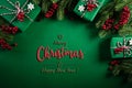 Christmas background concept. Top view of Christmas green gift box with decoration, spruce branches and red berries on green Royalty Free Stock Photo