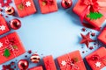 Christmas background concept. Top view of Christmas red gift box with candy cane, snowflakes, red berries and bell on blue pastel Royalty Free Stock Photo