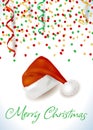 Christmas background with confetti, streamers, santa hat and text. Royalty Free Stock Photo