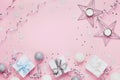 Christmas background with copy space for greeting text. Gift boxes and decoration on pink table top view. Flat lay. Royalty Free Stock Photo
