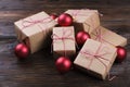 Christmas background with craft gift boxes and red balls on wooden background Royalty Free Stock Photo