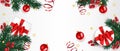 Christmas background decorated with gifts box, green pine branches,  snowflake, holly berry, and red ball. Royalty Free Stock Photo